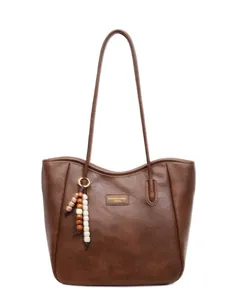 Retro brown leather tote bag with stylish bead charms and a spacious commuter design