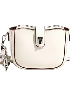 Minimalist cream saddle bag with brown trim and silver star pendant for women