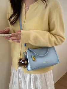 Light blue vintage Boston bag with pebbled leather finish and cute plush charm detail