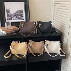 Five assorted vintage crossbody bags in litchi leather displayed on a black shelf