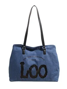 Deep blue denim tote bag with black straps and Carry Your Joy Everywhere slogan print