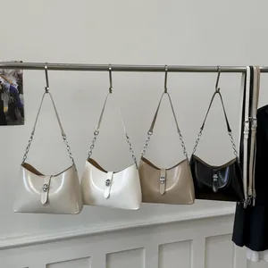 Polished leather crescent shoulder bag with chain strap in cream, white, khaki, and black