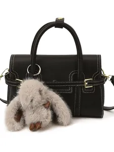 Retro black crossbody bag with white stitching and a cute grey plush rabbit pendant