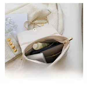 Internal view showing large capacity of quilted cream leather chain crossbody bag