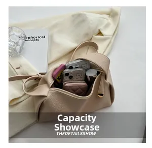 Macro shot showing internal capacity of the beige litchi grain leather crossbody bag