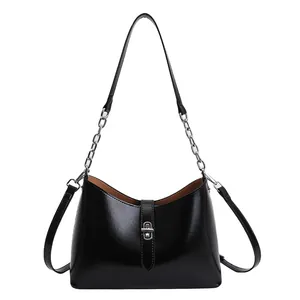 Glossy black underarm bag with silver twist lock and chain strap for luxury commute style
