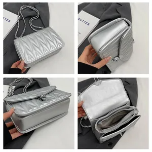 Detailed interior and exterior views of a silver quilted chain bag with turn-lock closure