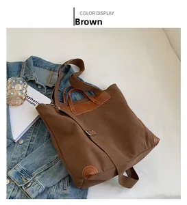 Top view of large brown canvas tote bag with leather handles and adjustable shoulder strap