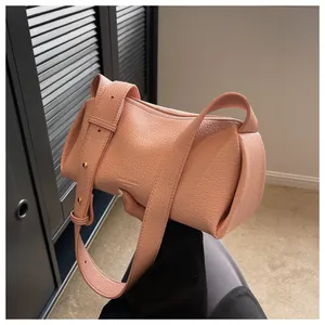 Detail of soft pink lychee pattern leather crossbody bag with chic wide shoulder strap