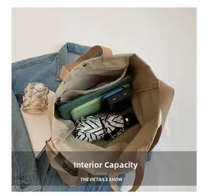 Detailed interior of a beige canvas tote bag showing large capacity for tablet and items