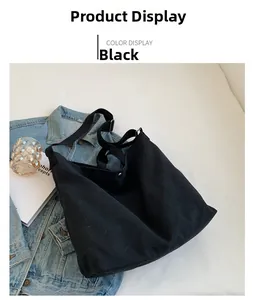 Flat lay of black canvas crossbody bag with wide strap and minimalist design details