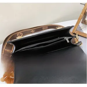 Internal view showing multi-layer compartments and zip pocket of black shoulder bag