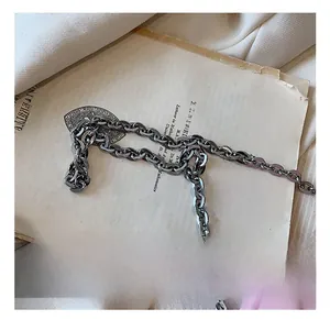 Detail of silver thick alloy chain strap with industrial metal texture and oval links