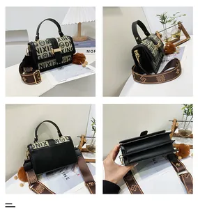Close-up of vintage black leather and beige patterned crossbody bag with three inner layers