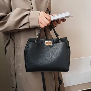 Minimalist black lychee texture PU leather shoulder bag with gold twist lock and handle