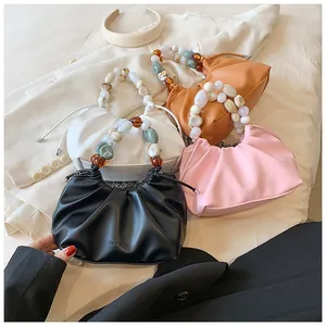 Detail view of stylish ruched bags in four colors with decorative acrylic bead handles