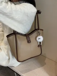 Khaki large capacity tote bag with dark brown trim and plush charm for women
