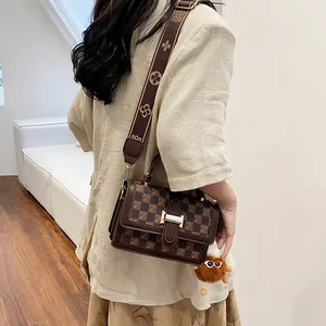 Vintage brown checkered crossbody bag with floral wide strap and plush pendant detail
