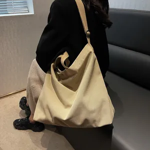 Large capacity canvas tote bag in khaki with adjustable shoulder strap for daily casual use