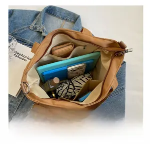 Spacious interior of khaki canvas tote bag showing multiple pockets and daily essentials