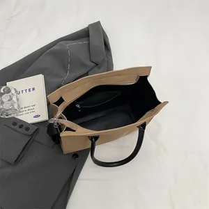 Detail view of khaki tote bag interior with spacious compartment and secure zipper pocket
