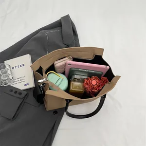 Spacious khaki tote bag interior showing capacity for tablet, umbrella and water bottle