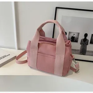 Detailed macro view of high-quality pink canvas bag with sturdy silver metal buckles