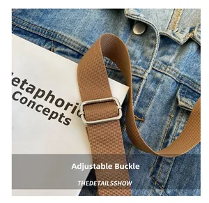 Detail of adjustable woven brown shoulder strap with polished silver metal buckle