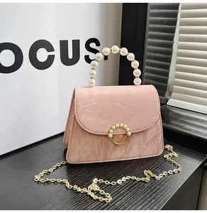 Detail showing pink marble texture leather with pearl handle and gold ring buckle