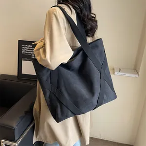 Large black canvas tote bag for women featuring reinforced straps for daily commuting