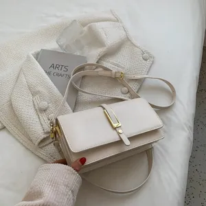 Minimalist beige rectangular crossbody bag with elegant gold vertical metal buckle