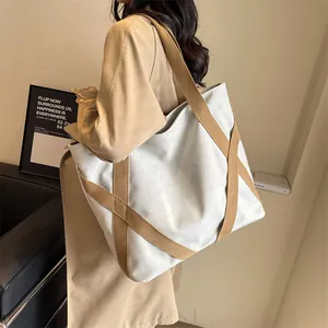 Minimalist cream canvas tote bag with large capacity and brown X-shaped strap design
