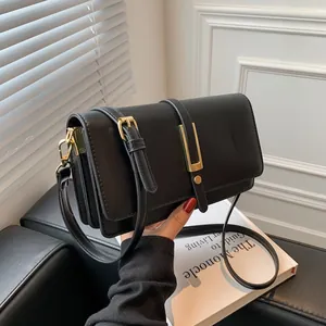 Classic black leather crossbody bag with structured flap and elegant gold hardware details
