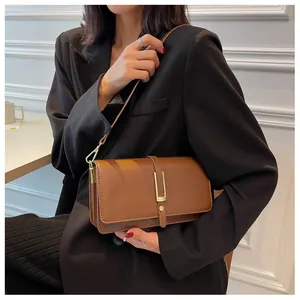 Detailed side view of a brown vintage square bag on model showing size and texture