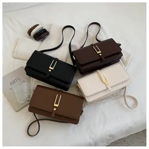 Detail view of rectangular crossbody bags in four colors with gold U-shaped buckles