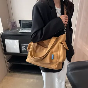 Close-up of ginger canvas tote bag with adjustable shoulder strap in office setting