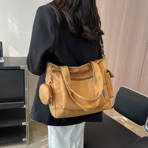 Detailed back view of a large canvas tote bag in mustard yellow with a matching coin purse
