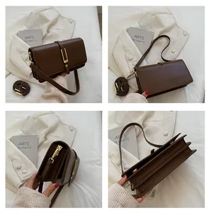 Detail of dark brown retro crossbody bag featuring triple accordion gussets and gold hardware