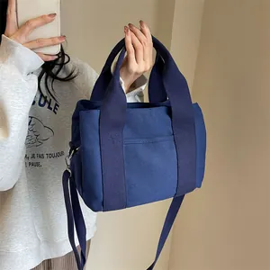 Blue canvas tote bag with adjustable shoulder strap for casual daily use and commuting
