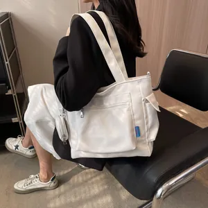 Detail of white large-capacity canvas tote bag with front zipper pocket and round pouch