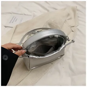 Top view of metallic silver bucket bag showing interior pocket and smooth texture