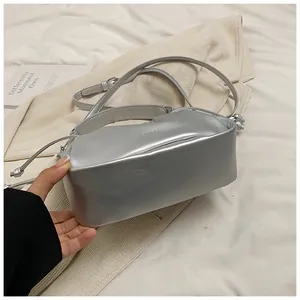 Detail shot of the metallic silver cloud bag with drawstring pleats and brand logo