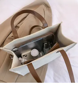 Top view of canvas tote bag interior showing large capacity and zipper compartment