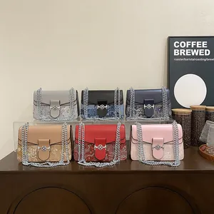 Detailed view of six vintage floral pattern flap bags with silver chain straps on wood