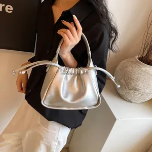 Close-up of silver pleated drawstring handbag with minimalist cliriab logo lettering