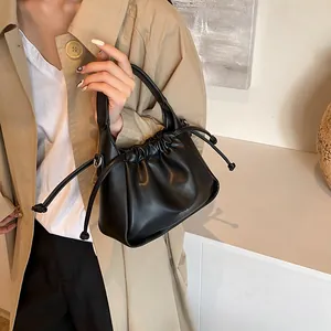 Close-up of black drawstring cloud bag featuring premium pleated faux leather texture