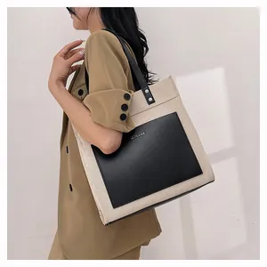 Detail shot of the large canvas tote bag with black leather pocket and Mycare logo