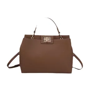 Chic brown lychee leather shoulder bag with gold twist lock and adjustable strap