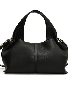 Modern black pebbled leather crossbody handbag with gold hardware and curved handle