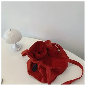 Detail of red nylon tote interior showing internal pocket and drawstring closure